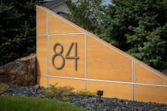 Residential House Numbers | Material: 3/8" aluminum | Finish: Brushed Aluminum | Font: TimeBurner | Size: Custom | Substrate: Custom wood wall